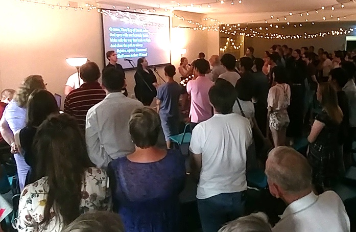 A crowd of people singing carols