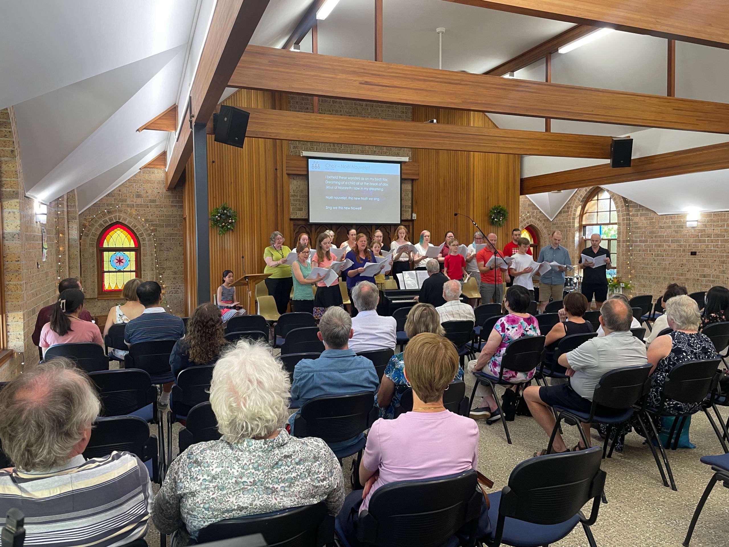 A crowd in a church listening to a choir.